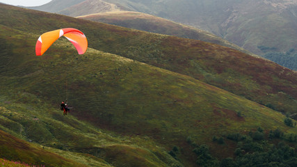 red yellow parachute in the mountains Summer