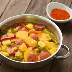 Hungarian dish called Paprikas Krumpli (Potato with Paprika), a stew made of potato, onion, pepper, tomato and sausage (Selective Focus, Focus in the middle of the dish)