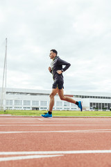 Fototapeta premium Attractive man Track Athlete Running On Track