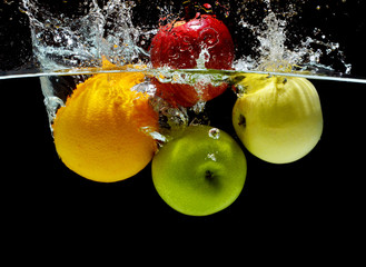 Splashing fruit on water. Fresh Fruit and Vegetables being shot as they submerged under water.