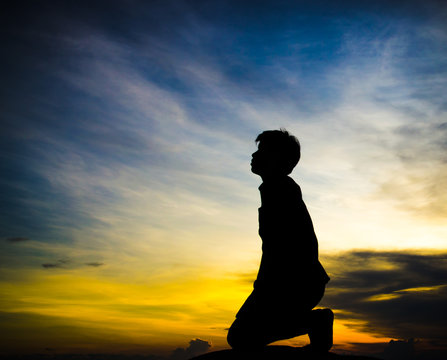praying man on beautiful sky background