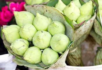 Green lotus bunch wrap by lotus leaves in market.