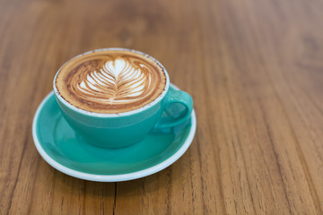 Hot latte coffee on green cup and  plate