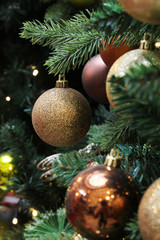 Golden christmas tree ball ornaments on tree