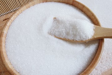 Fototapeta na wymiar white sugar in wood spoon