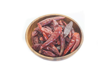 Dried chili pepper in wooden bowl on white background