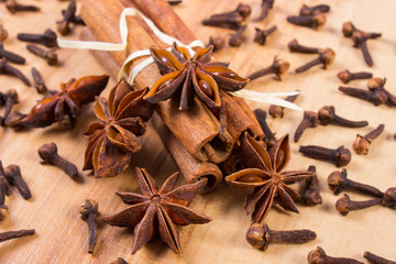 Star anise, cinnamon sticks and cloves on wooden table, seasoning for cooking