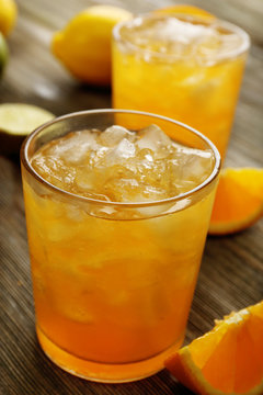 Glasses of orange juice on wooden table, closeup