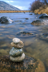 Closeup of stacked rocks in river.