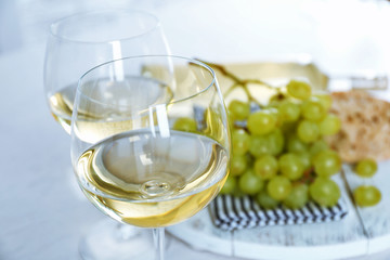 Still life of wine and bread on light background