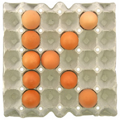 A letter K from the eggs in paper tray