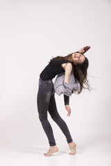 playful girl, dancing in studio freestyle, wild. white backgroun