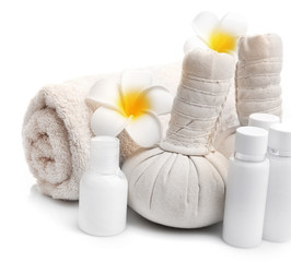 Fototapeta na wymiar Spa set with massage balls, towel, aroma oil and frangipani flower isolated on white