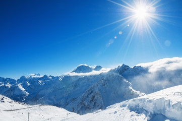 Beautiful winter landscape with snow-covered mountains and blue
