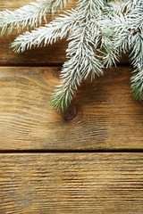 Christmas tree with frost on old wooden table
