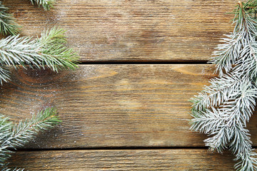 Christmas tree with frost on old wooden table