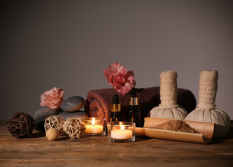 Beautiful spa set on wooden table against grey background
