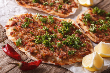 Turkish pizza with meat - lahmacun macro on the table. Horizontal
