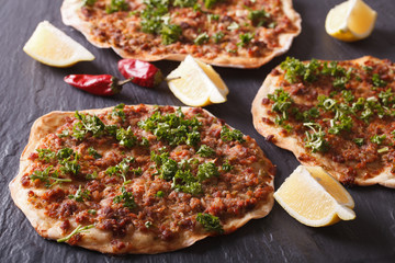 Turkish pizza lahmacun closeup on a stone table. horizontal
