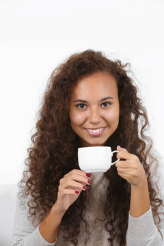 Close up portrait of pretty young woman drinking coffee on white background