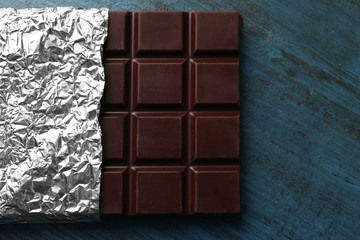 Dark Chocolate bar in foil  on gray background