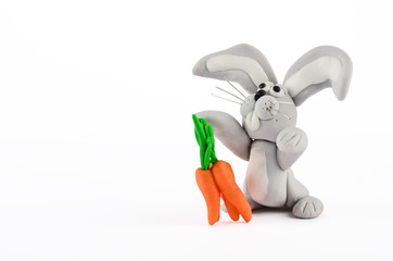 Baby rabbit and carrots statue isolated on white