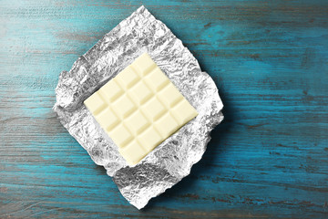 White Chocolate bar in foil  on gray background