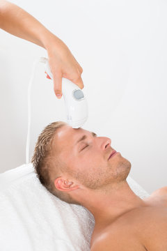 Young Man Receiving Laser Hair Removal Treatment