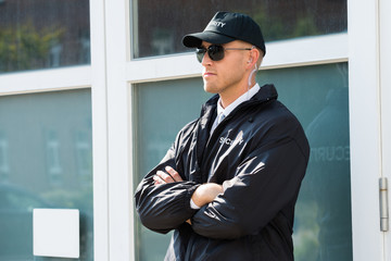 Male Security Guard Standing At The Entrance