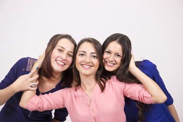 Three young girls, having fun. studio shot, white background.