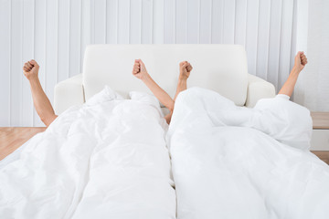 Couple Waking Up In Bed