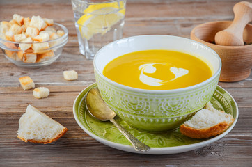 Pumpkin soup on the wooden table