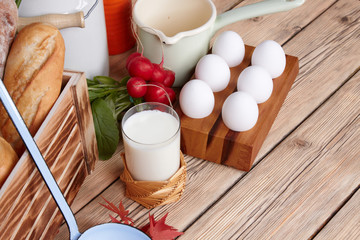 Dairy products on wooden table. Sour cream, milk, cheese, egg, 