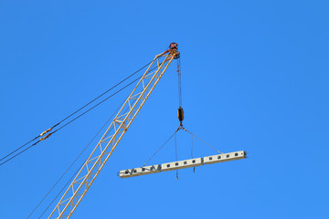 Crane hook with load and for building under construction 