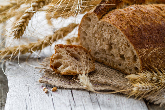 Bread, rye, wheat, rustic wood background