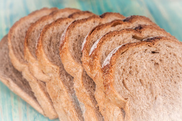 Slices of rye bread  on wood background ,vintage tone