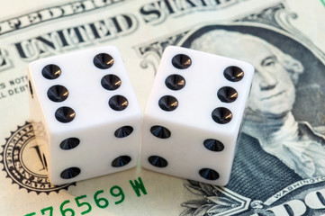 Close up of white dice and dollar cash money