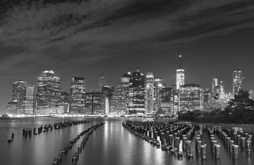 Black and white photo of Manhattan waterfront at night, NYC, USA