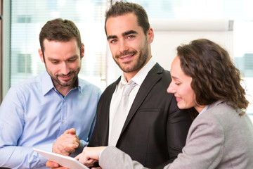 Group of business associates working together at the office