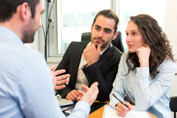 Attractive boss doing interview with his assistant