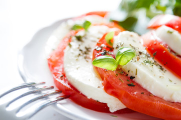 Caprese salad on white plate, closeup