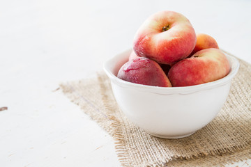 Peaches in white bowl