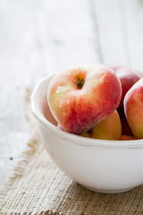 Peaches in white bowl