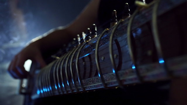 Man Playing Raga the Sitar. Closeup. Eastern Music. Indian traditional string instrument. Evening concert.