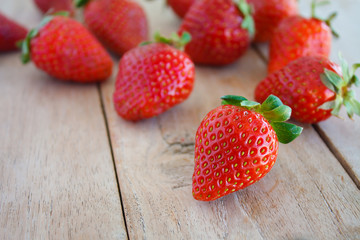 Fresh red strawberries on wooden table