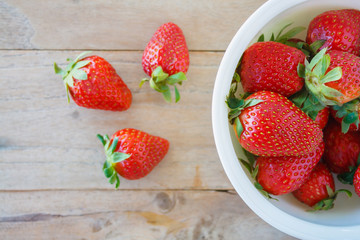 Ripe red strawberries on wooden table