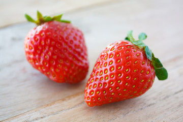 Ripe red strawberries on wooden table