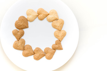 Chocolate cookies and butter cookies on white dish on white background