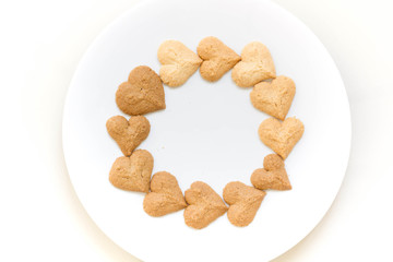 Chocolate cookies and butter cookies on white dish on white background