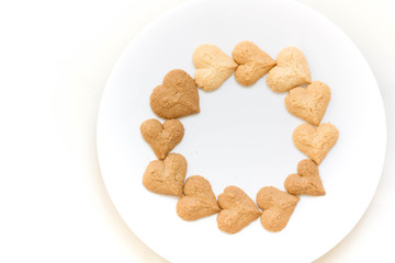 Chocolate cookies and butter cookies on white dish on white background